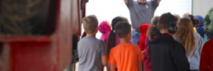 Youngblut Ag’s Garrett Princehouse, center back, explains how to stay safe around a crop sprayer to DG Elementary students in Sherry Parker’s second-grade class